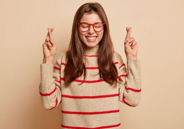woman with fingers crossed