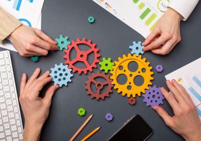 team moving cogs on table